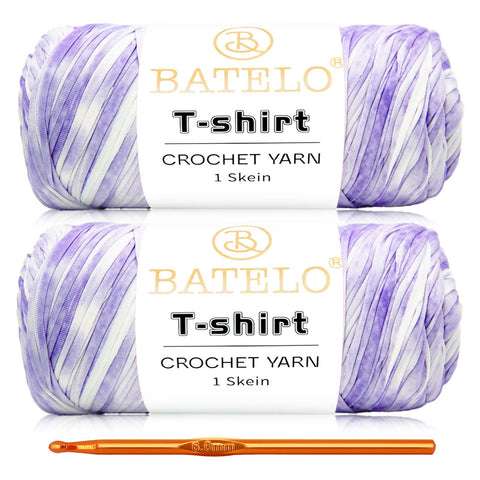 Two lavender-and-white variegated BATELO T-shirt yarn skeins with a gold crochet hook on a white background
