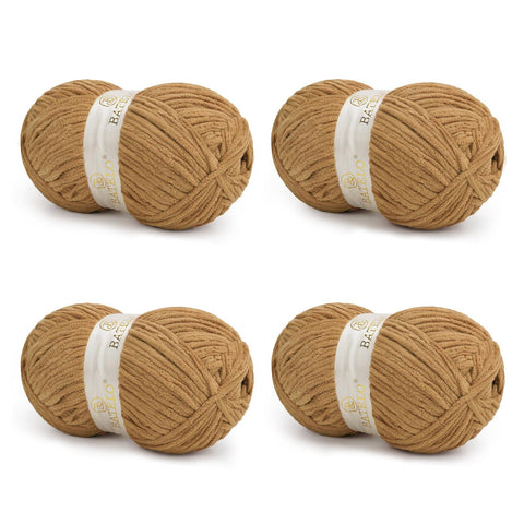 Four tan BATELO bulky chenille blanket yarn skeins arranged on a white background