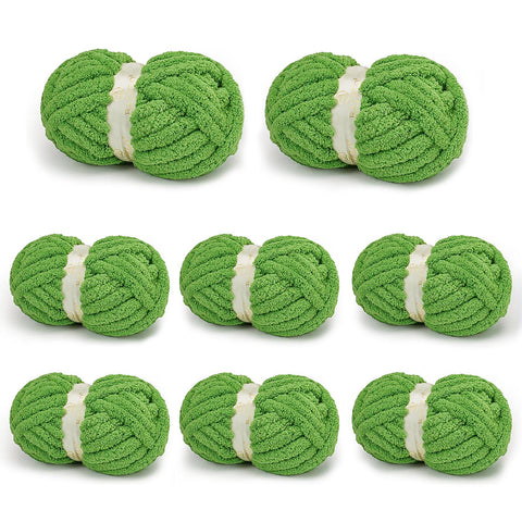 Eight bright green BATELO chunky chenille yarn skeins arranged on a white background