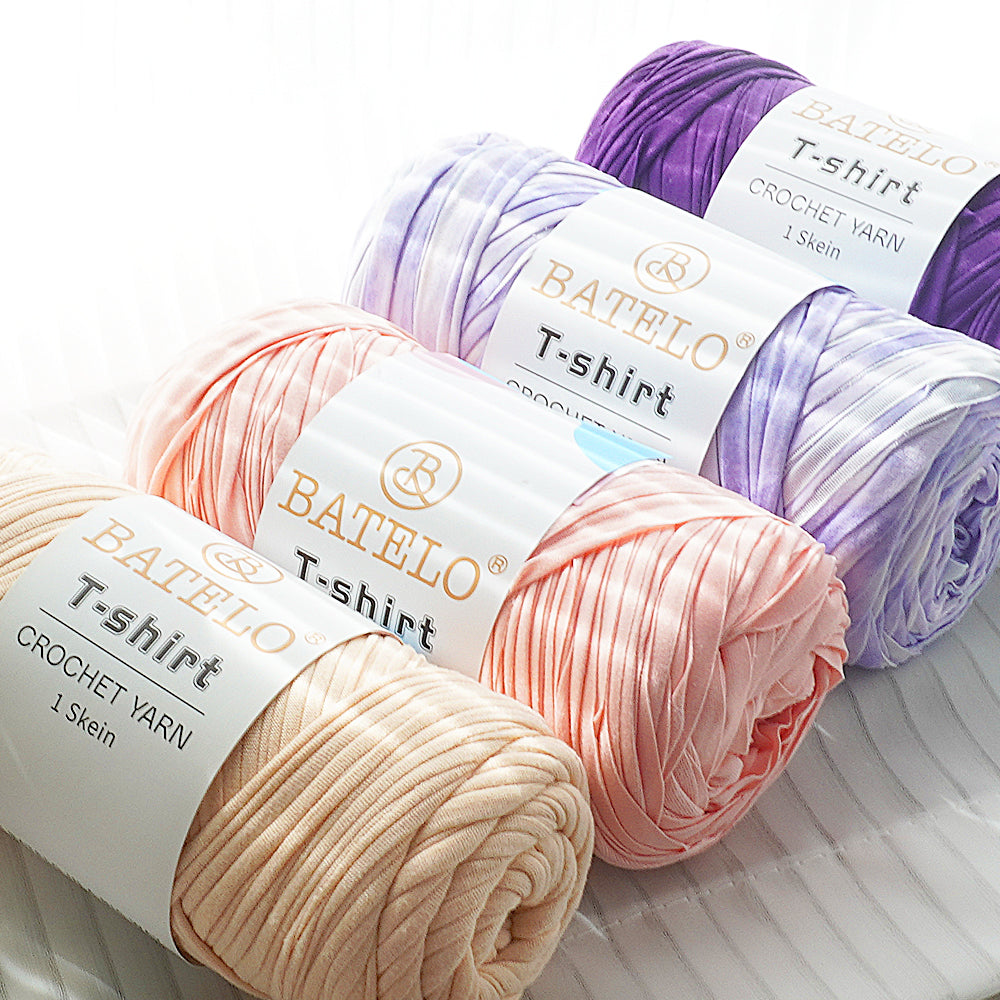 Pastel BATELO T-shirt yarn skeins in pink, lavender, purple, and cream on a white background