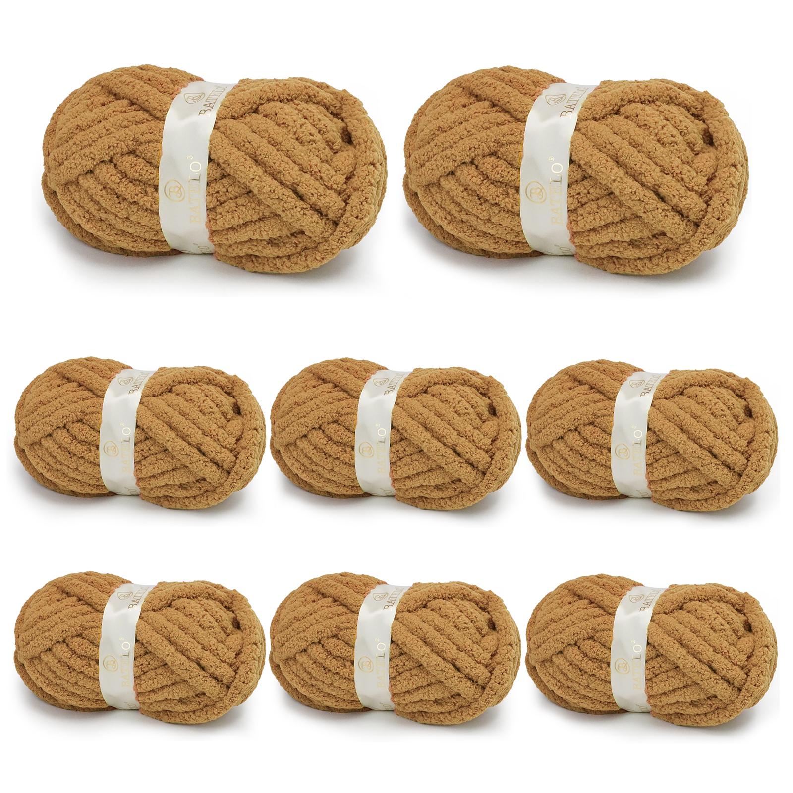 Eight warm tan BATELO chunky chenille yarn skeins arranged on a white background