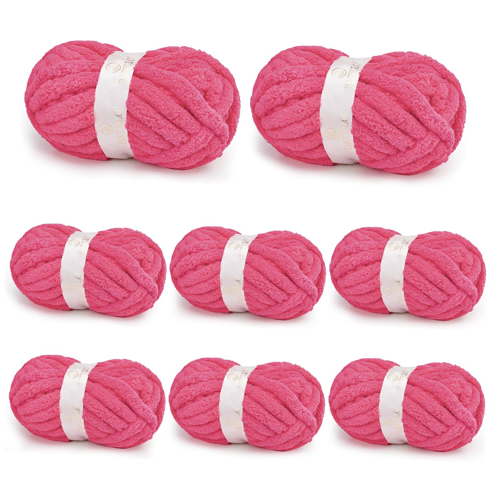 Eight hot pink BATELO chunky chenille yarn skeins arranged on a white background