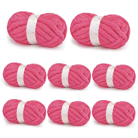 Eight hot pink BATELO chunky chenille yarn skeins arranged on a white background