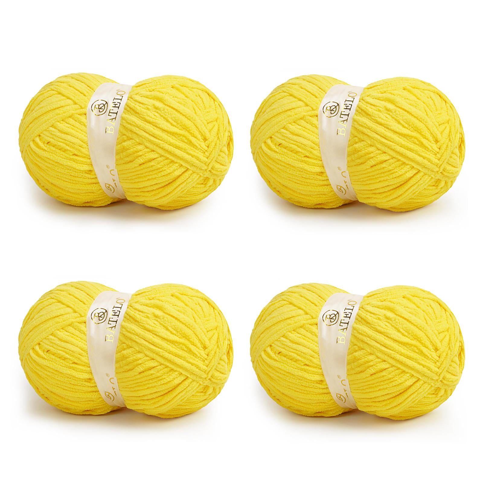 Four yellow BATELO bulky chenille blanket yarn skeins arranged on a white background