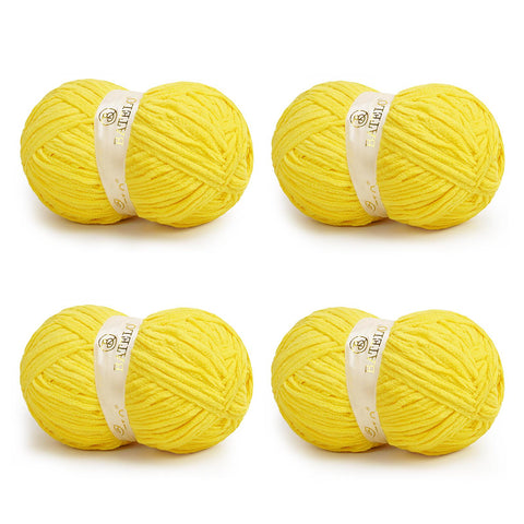 Four yellow BATELO bulky chenille blanket yarn skeins arranged on a white background