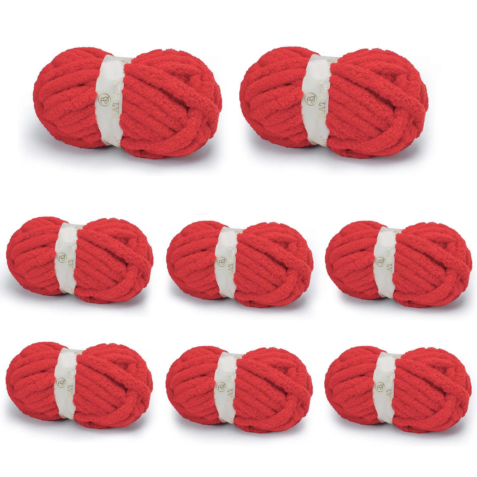 Eight red BATELO chunky chenille yarn skeins arranged on a white background