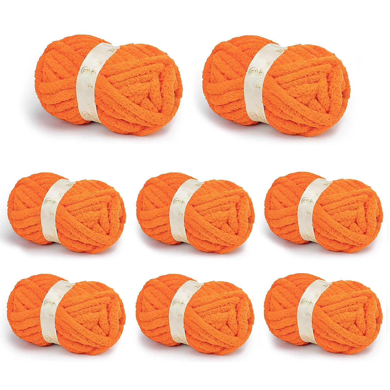 Eight orange BATELO chunky chenille yarn skeins arranged on a white background