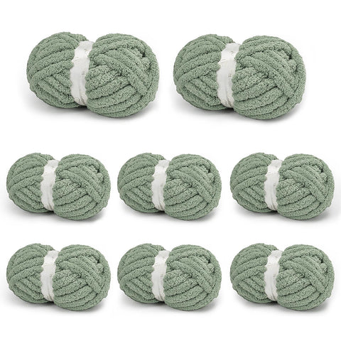 Eight sage gray BATELO chunky chenille yarn skeins arranged on a white background