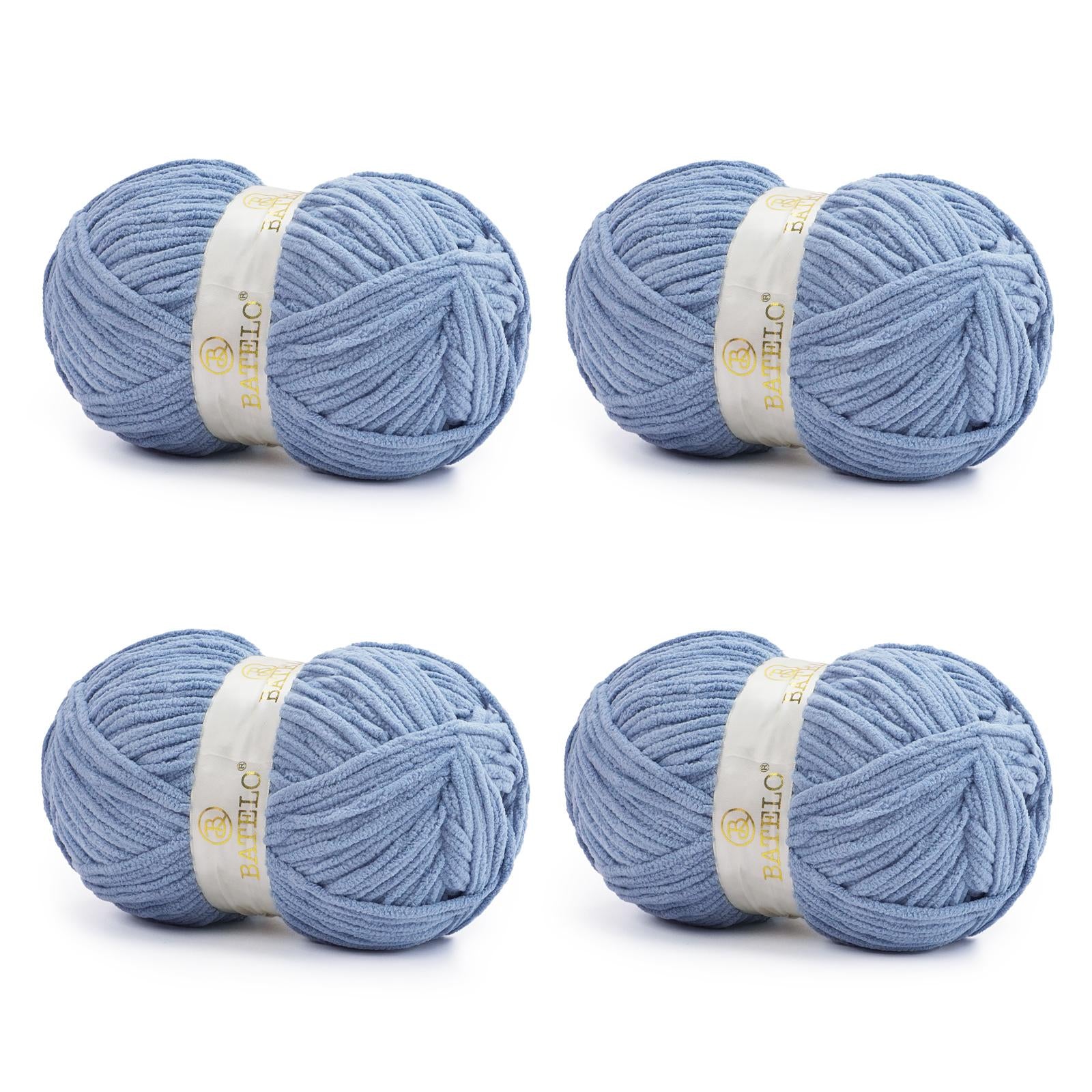 Four dusty blue BATELO bulky chenille blanket yarn skeins arranged on a white background