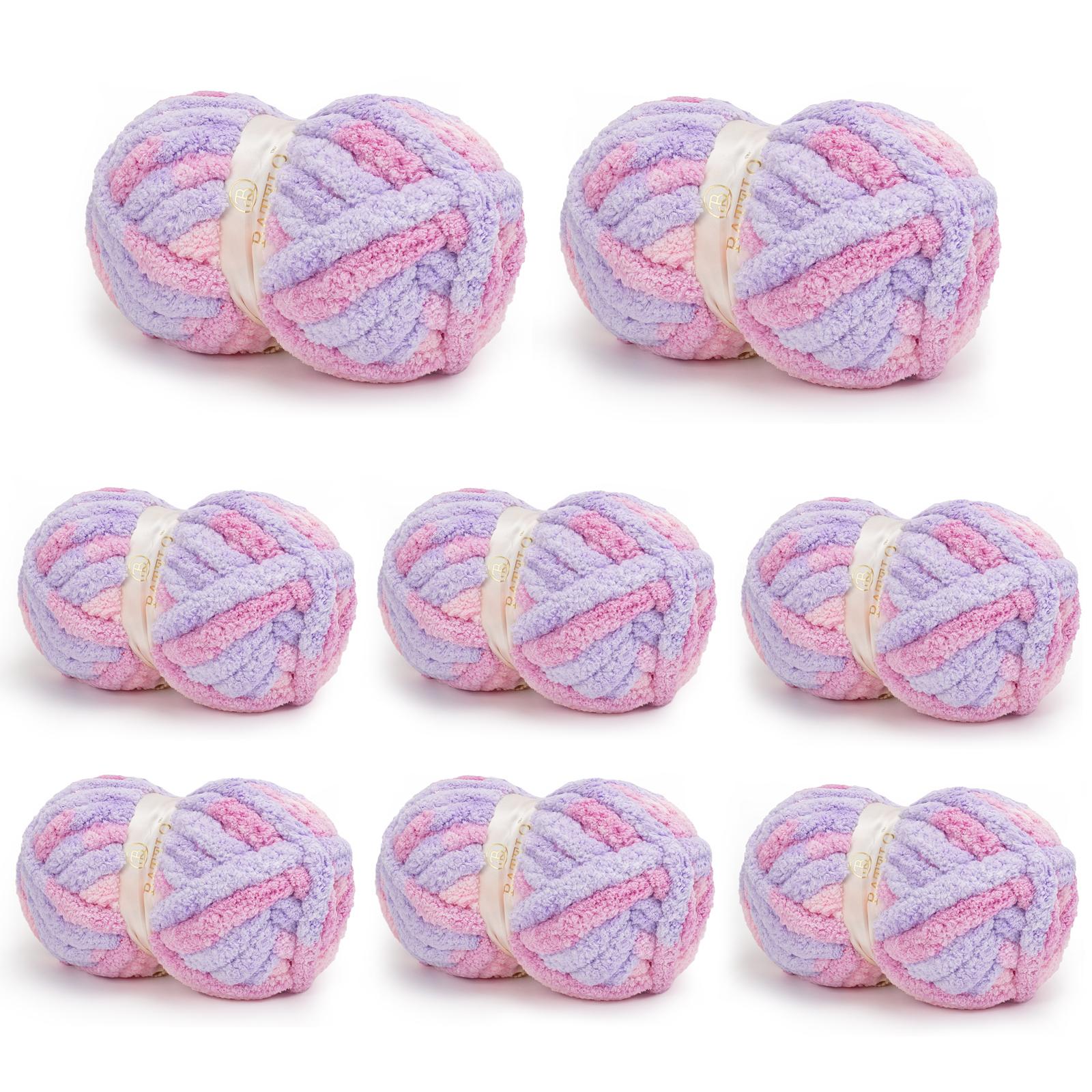 Eight pink-and-lavender variegated BATELO chunky chenille yarn skeins arranged on a white background