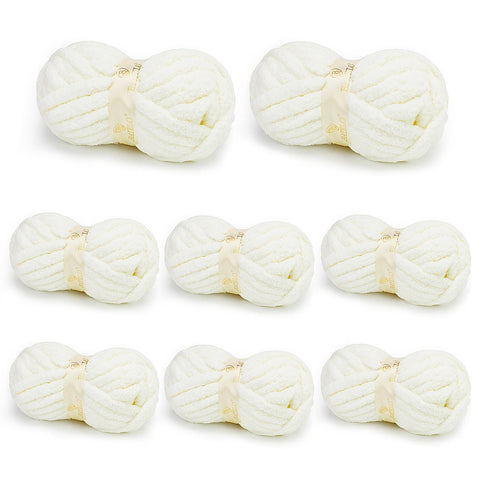Eight white BATELO chunky chenille yarn skeins arranged on a white background