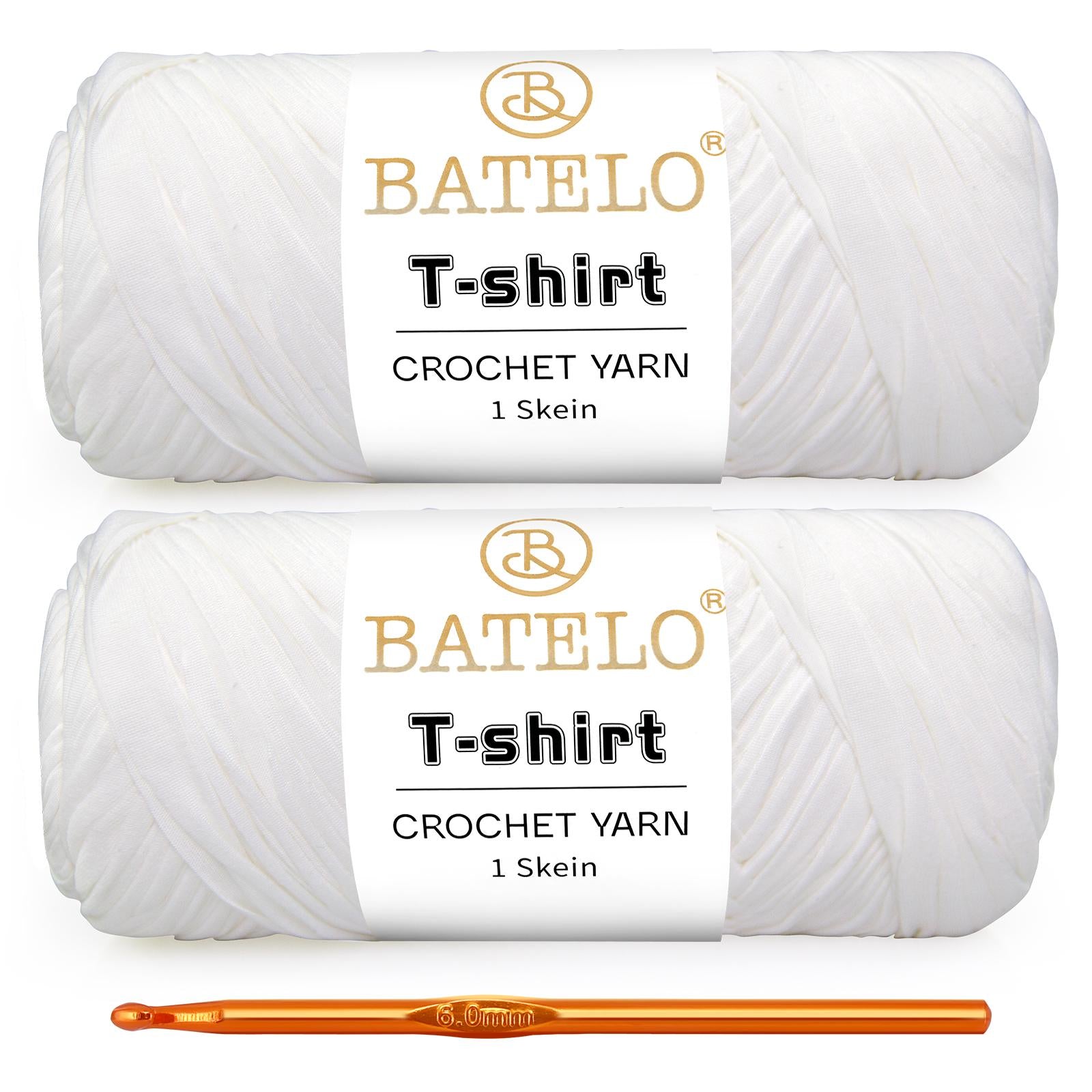 Two white BATELO T-shirt yarn skeins with a gold crochet hook on a white background
