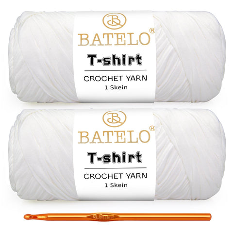 Two white BATELO T-shirt yarn skeins with a gold crochet hook on a white background
