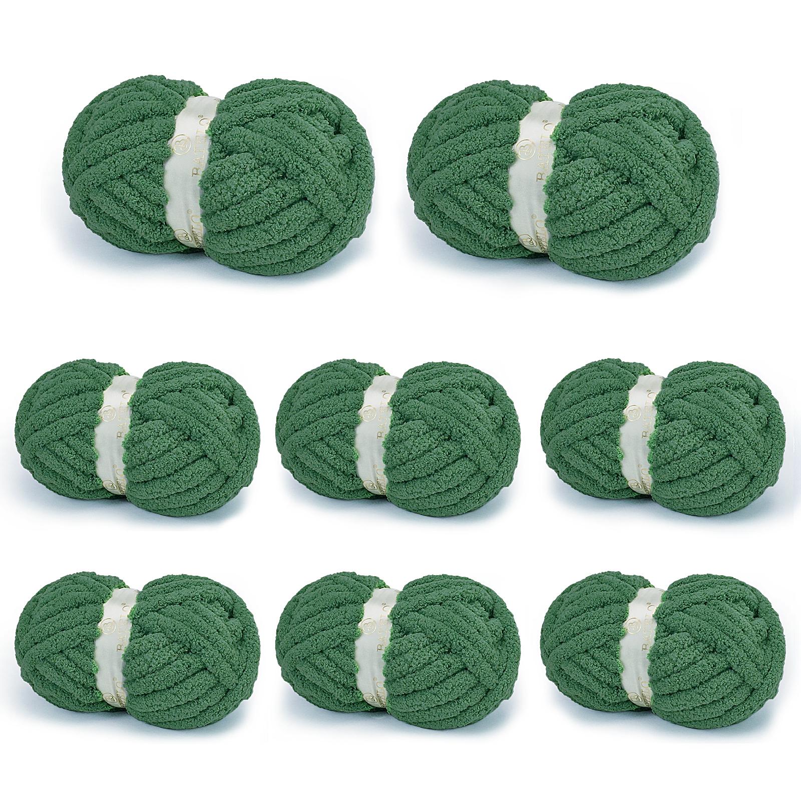 Eight dark green BATELO chunky chenille yarn skeins arranged on a white background