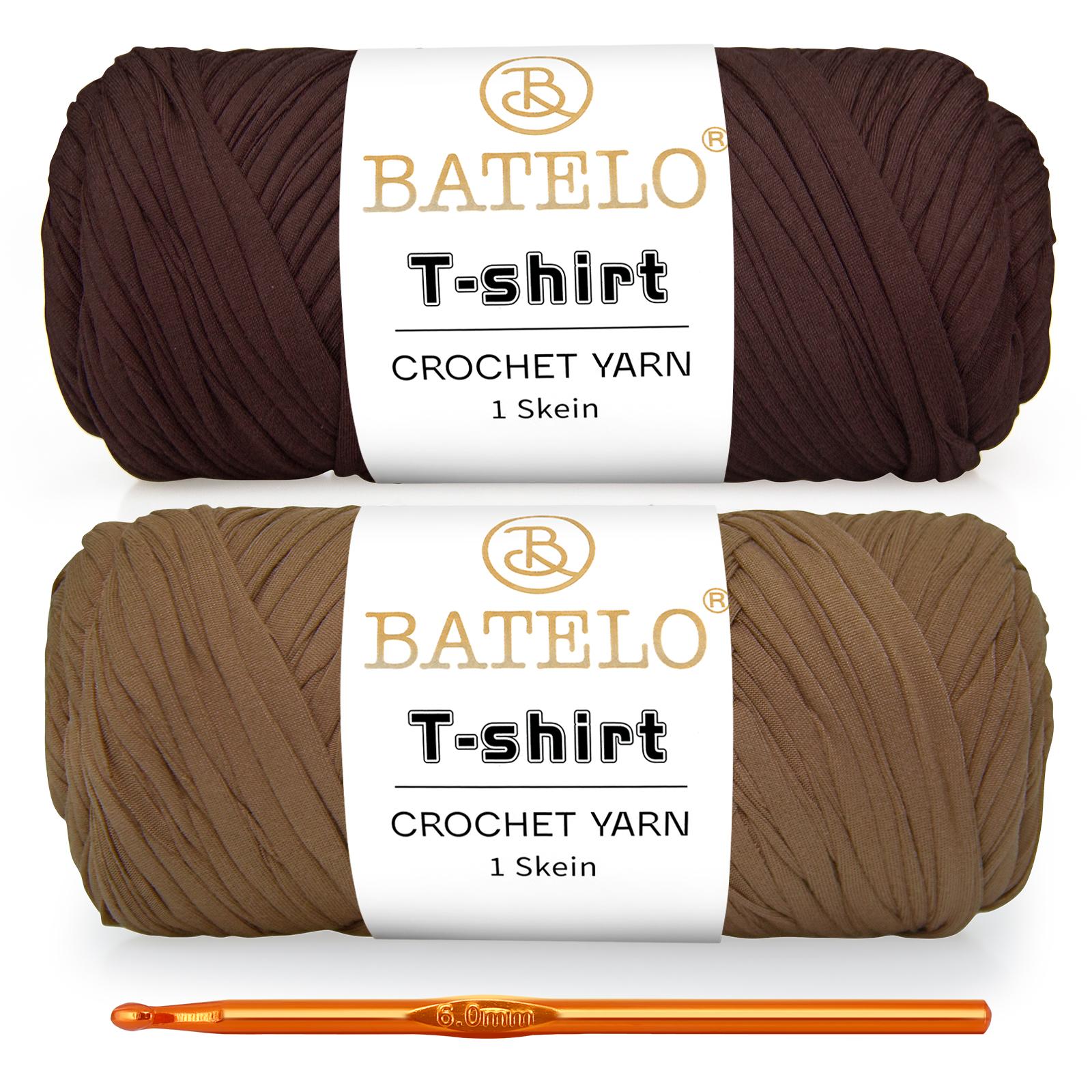 Two brown and tan BATELO T-shirt yarn skeins with a gold crochet hook on a white background