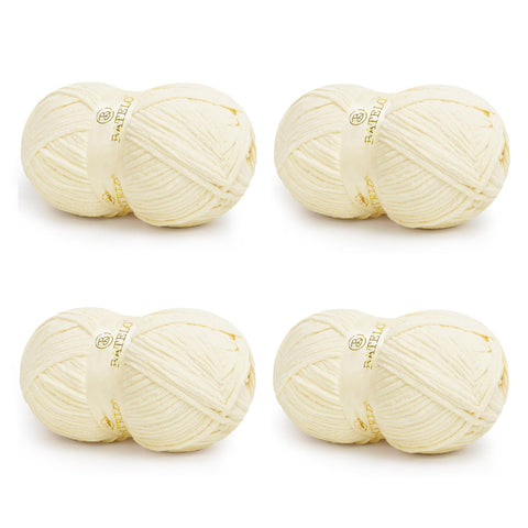 Four cream BATELO bulky chenille blanket yarn skeins arranged on a white background