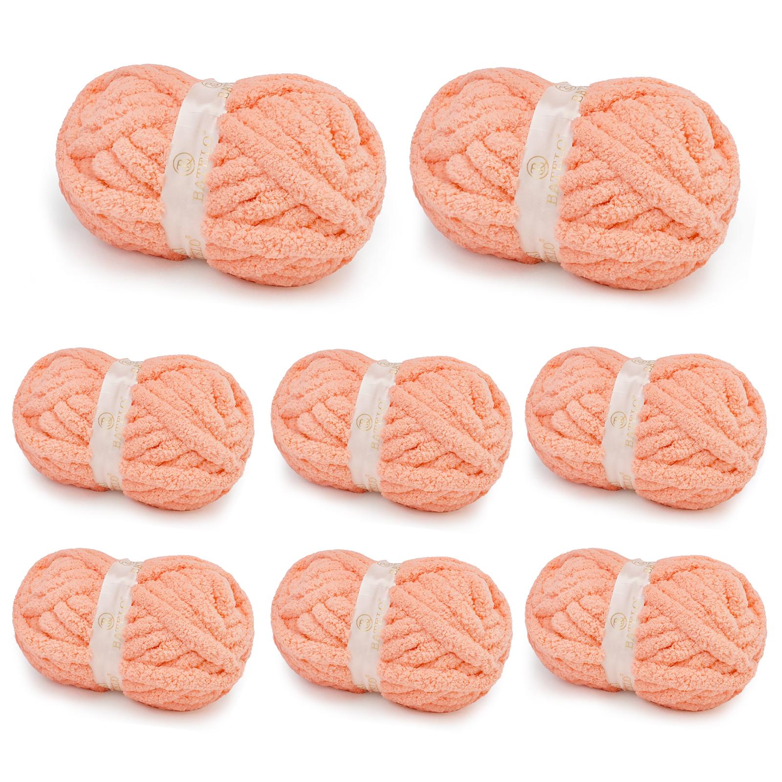 Eight soft peach BATELO chunky chenille yarn skeins arranged on a white background