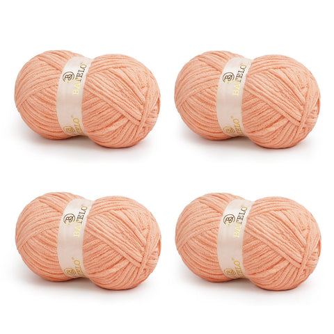 Four peach BATELO bulky chenille blanket yarn skeins arranged on a white background