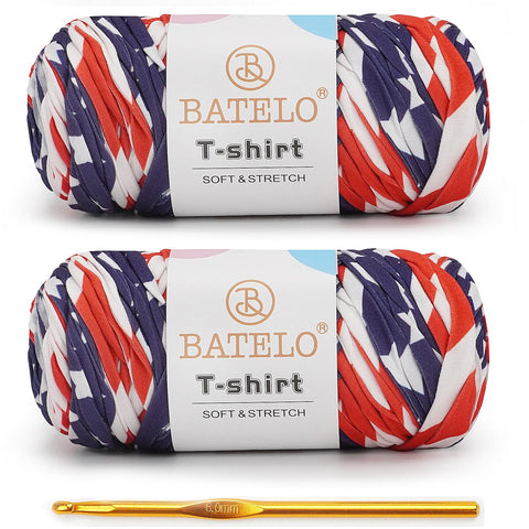 Two red, white, and navy geometric-print BATELO T-shirt yarn skeins with a gold crochet hook on a white background