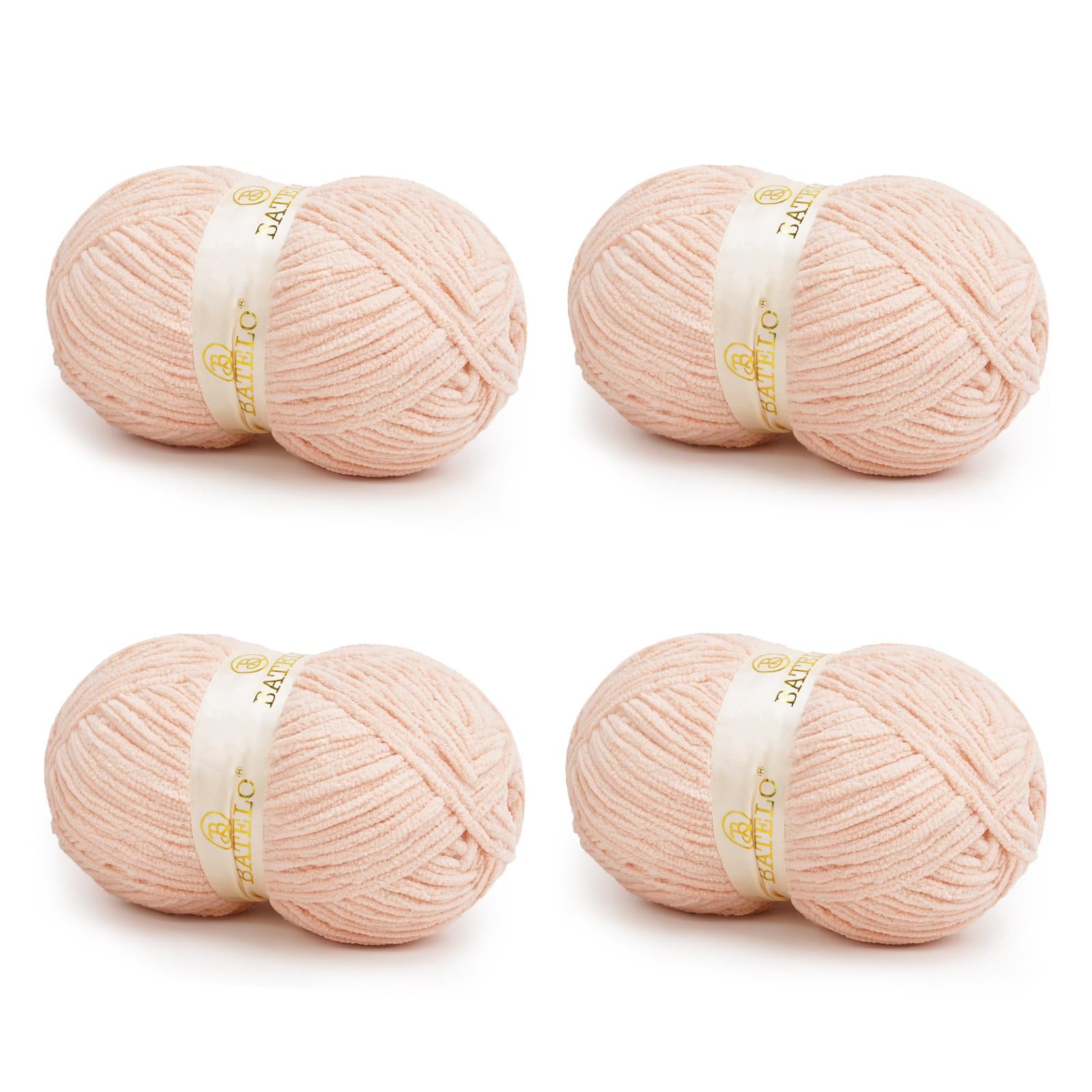 Four pale peach BATELO bulky chenille blanket yarn skeins arranged on a white background