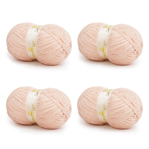 Four pale peach BATELO bulky chenille blanket yarn skeins arranged on a white background