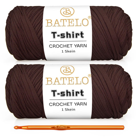 Two dark brown BATELO T-shirt yarn skeins with a gold crochet hook on a white background