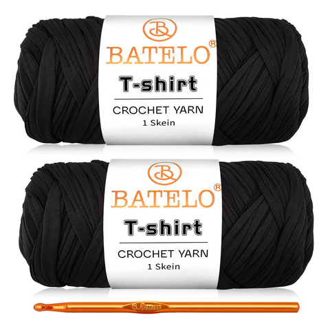 Two black BATELO T-shirt yarn skeins with a gold crochet hook on a white background
