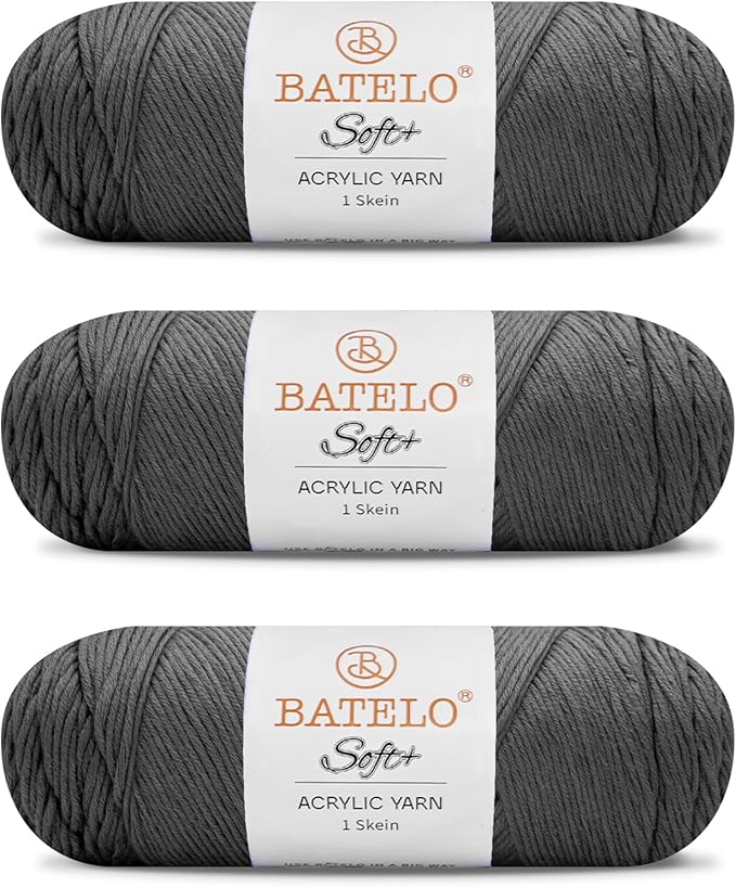 Three charcoal gray BATELO medium acrylic yarn skeins with white labels on a white background