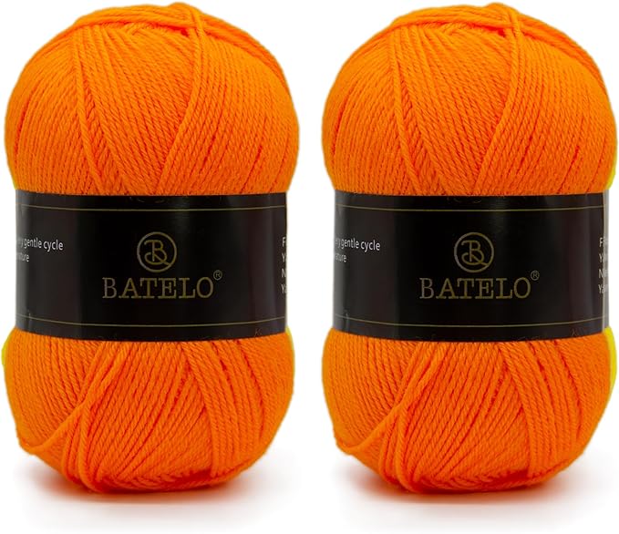 Two orange BATELO light acrylic yarn skeins with branded bands on a white background
