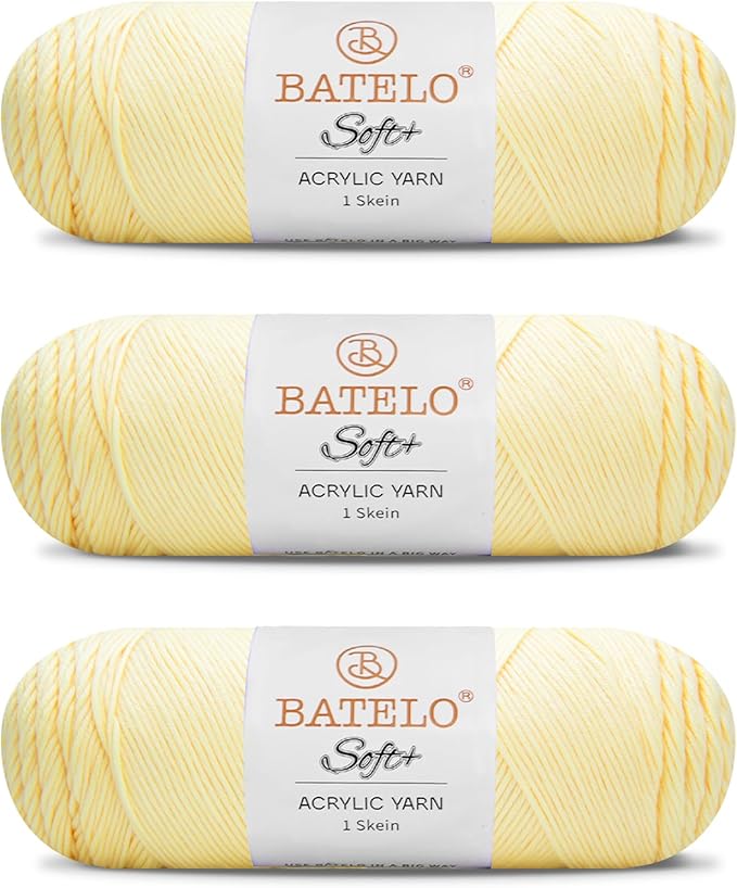 Three pale yellow BATELO medium acrylic yarn skeins with white labels on a white background