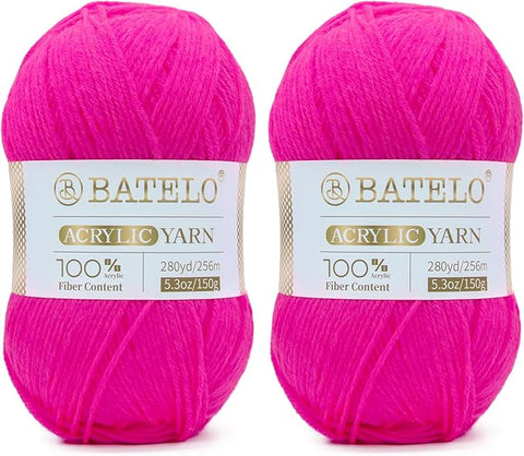 Two hot pink BATELO light acrylic yarn skeins with branded bands on a white background