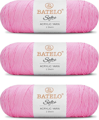Three light pink BATELO medium acrylic yarn skeins with white labels on a white background