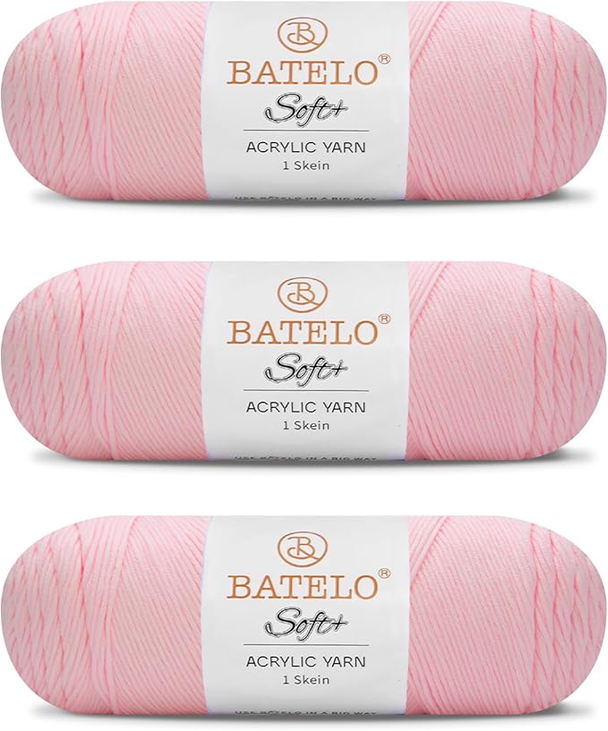 Three blush pink BATELO medium acrylic yarn skeins with white labels on a white background