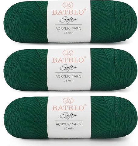 Three dark green BATELO medium acrylic yarn skeins with white labels on a white background