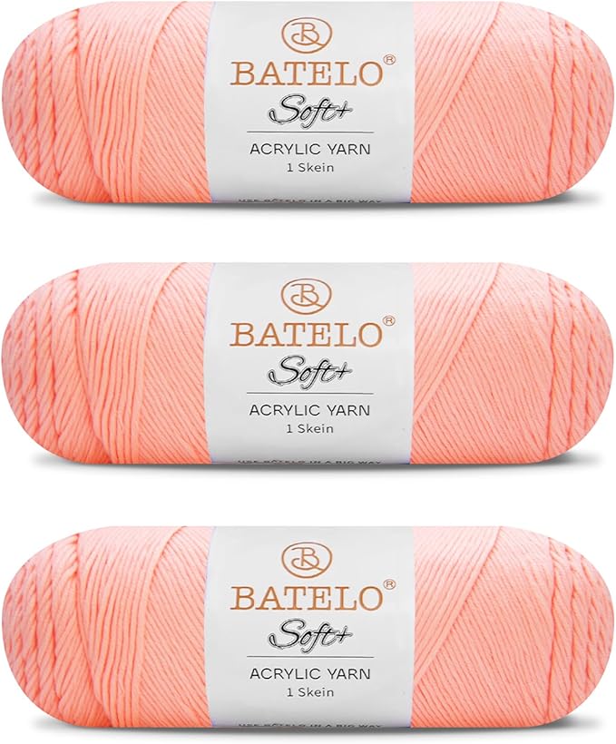Three peach BATELO medium acrylic yarn skeins with white labels on a white background