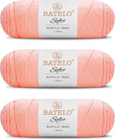 Three peach BATELO medium acrylic yarn skeins with white labels on a white background