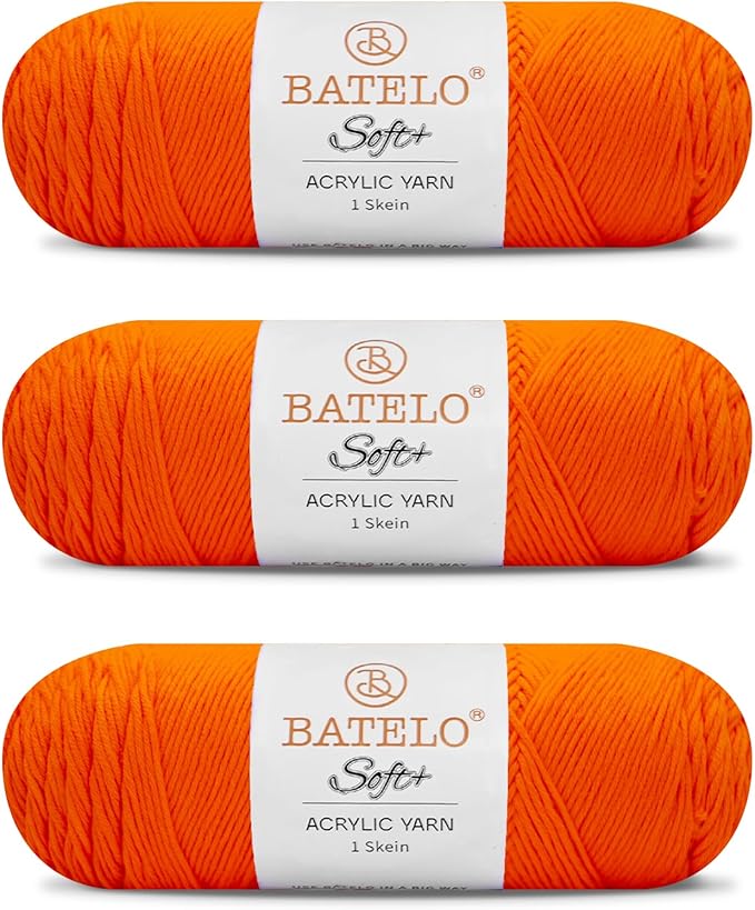 Three orange BATELO medium acrylic yarn skeins with white labels on a white background