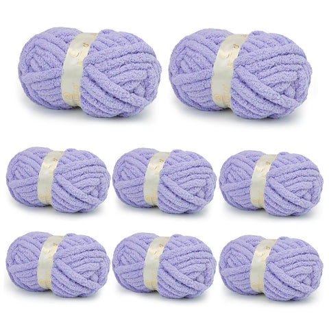 Eight lavender BATELO chunky chenille yarn skeins arranged on a white background
