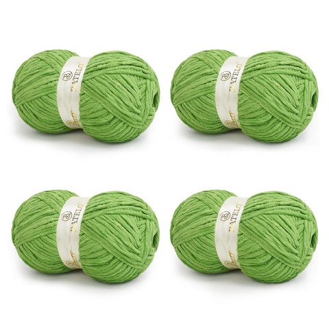 Four green BATELO bulky chenille blanket yarn skeins arranged on a white background